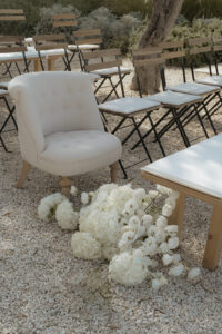 Outdoor wedding ceremony setup with white florals and chairs at Masseria Moroseta in Puglia Italy