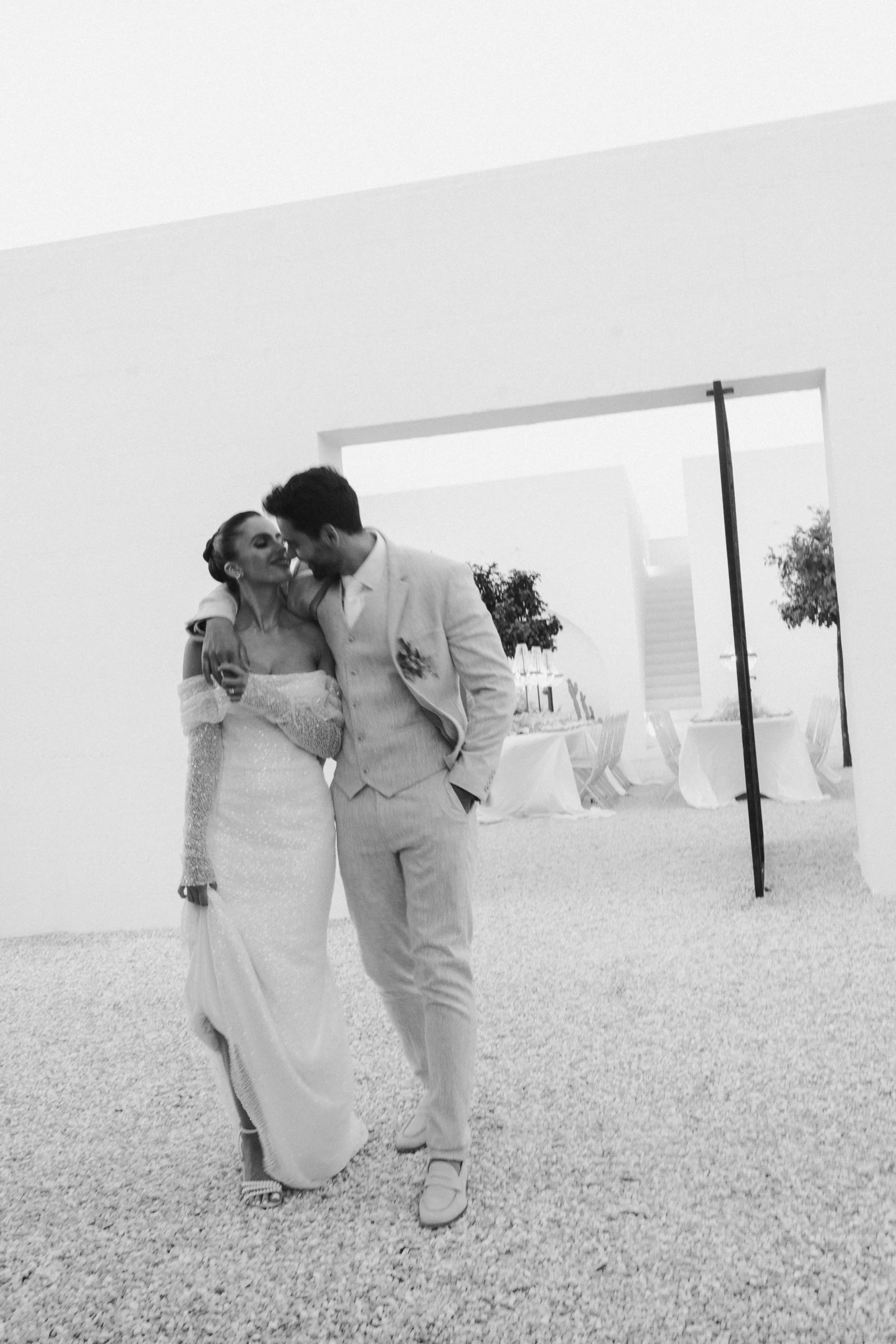 The two of you walking across the courtyard at Masseria Moroseta, his arm draped over your shoulders, a shared smile turning into a kiss. The kind of moment that doesn’t need posing — it just happens, and you never forget it.