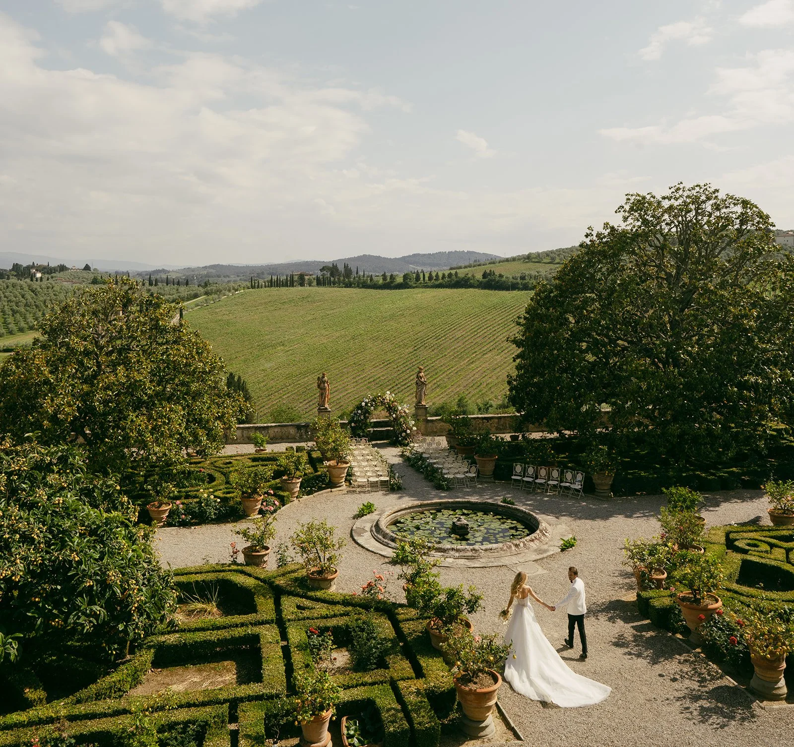  Bride and groom portrait session in beautifully manicured garden overlooking the rolling Tuscan hills 