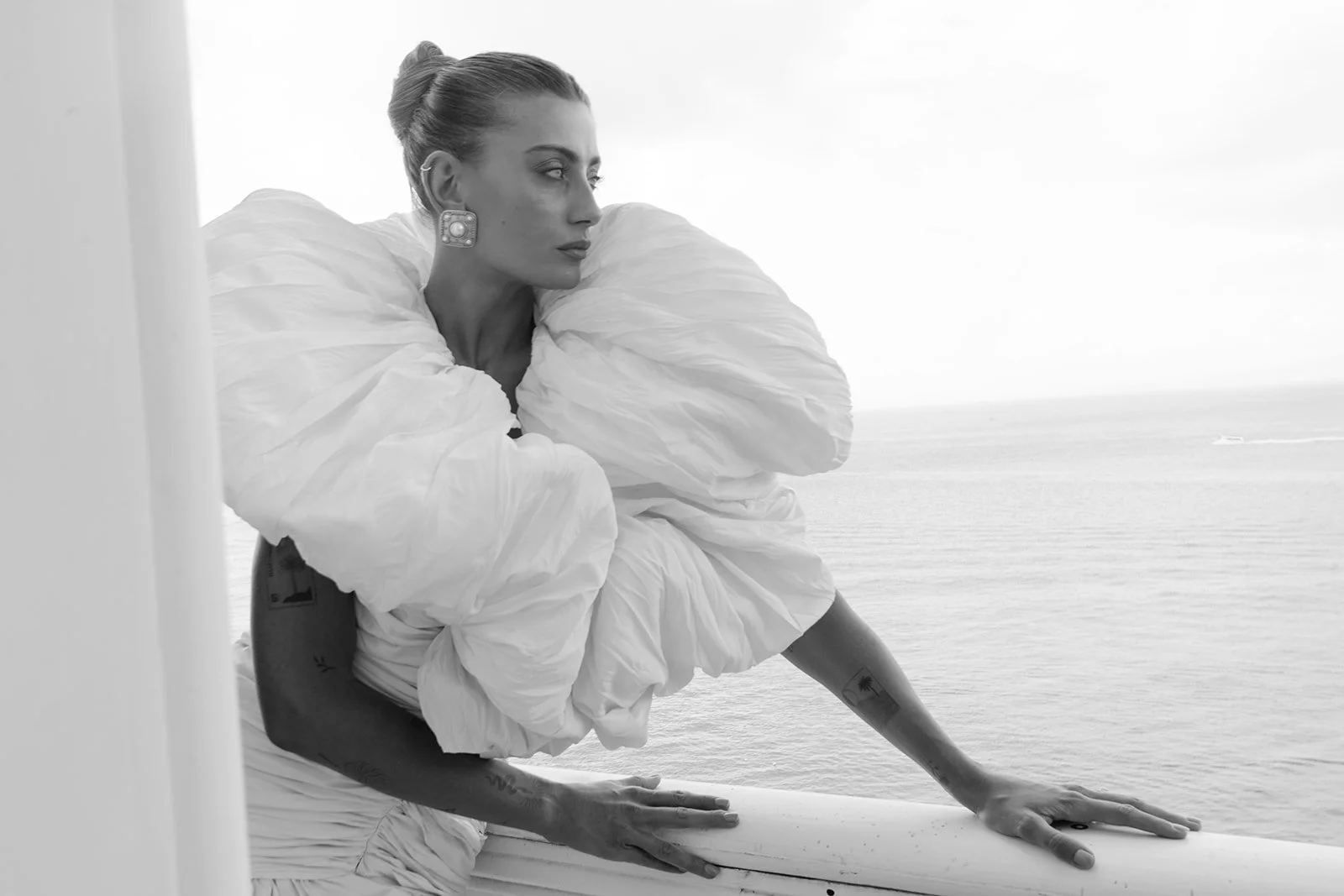  A quiet moment on the balcony of Villa Astor, overlooking the Amalfi Coast. Captured in profile, the bride's sculptural couture gown and statement earrings take center stage. This editorial wedding portrait blends fashion and storytelling—ideal for couples seeking a destination wedding photographer in Italy with an eye for timeless, high-style imagery. 