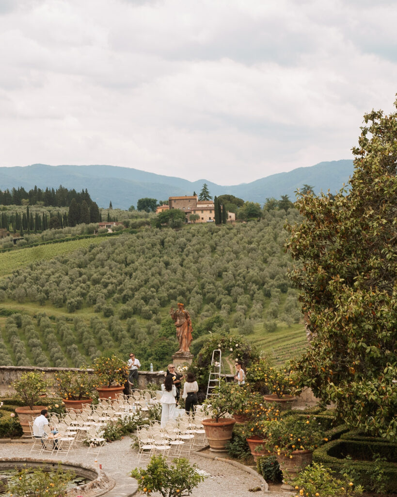 A Tuscany Wedding Styled at Villa Corsini: Timeless Editorial Inspiration in Italy Florists preparing the ceremony installation at Villa Corsini overlooking the Tuscan countryside in Florence, Italy before an editorial wedding celebration.