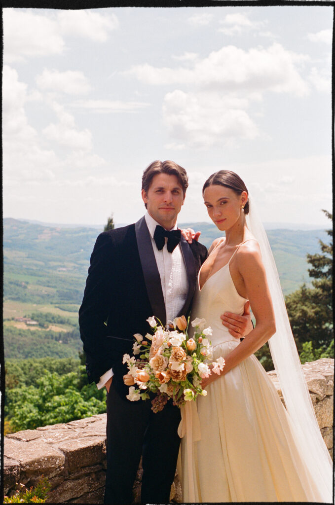 A Timeless Monteverdi Tuscany Wedding Bride and groom portrait overlooking Tuscan countryside at Monteverdi Tuscany