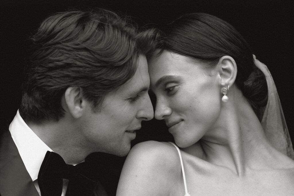 Bride and groom in black-and-white portrait touching foreheads in an intimate moment at Monteverdi Tuscany