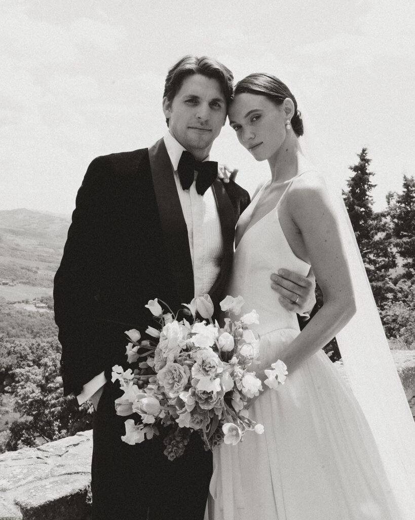 Bride in Danielle Frankel gown and Jane Rhyan The Collection veil with groom in black velvet tuxedo during portraits at Monteverdi Tuscany.