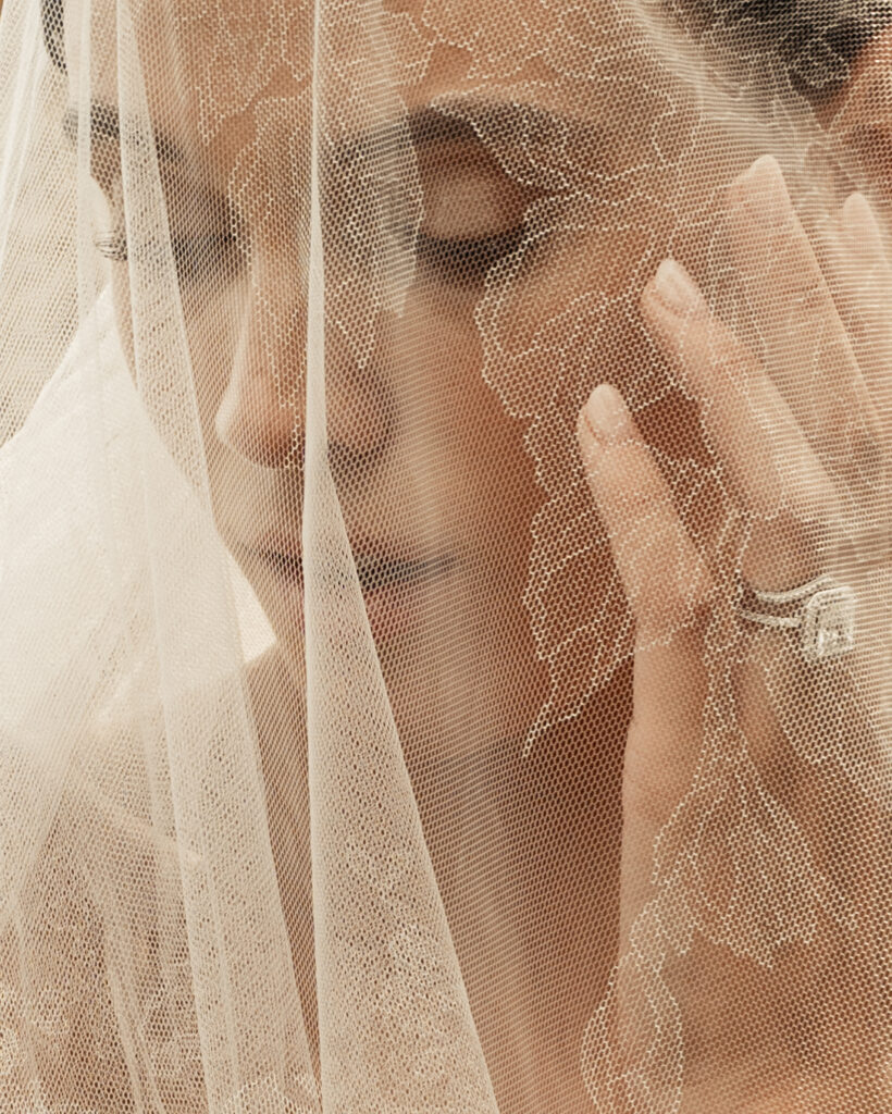 Close-up portrait of bride wearing a Jane Rhyan The Collection veil and Danielle Frankel gown at Monteverdi Tuscany.