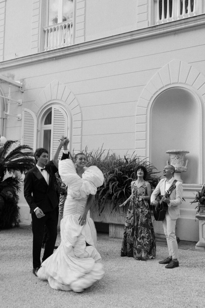 Why Luxury Wedding Photography Is About Trust, Not Shot Lists Bride and groom dancing among musicians and guests in an unposed, celebratory moment during a wedding