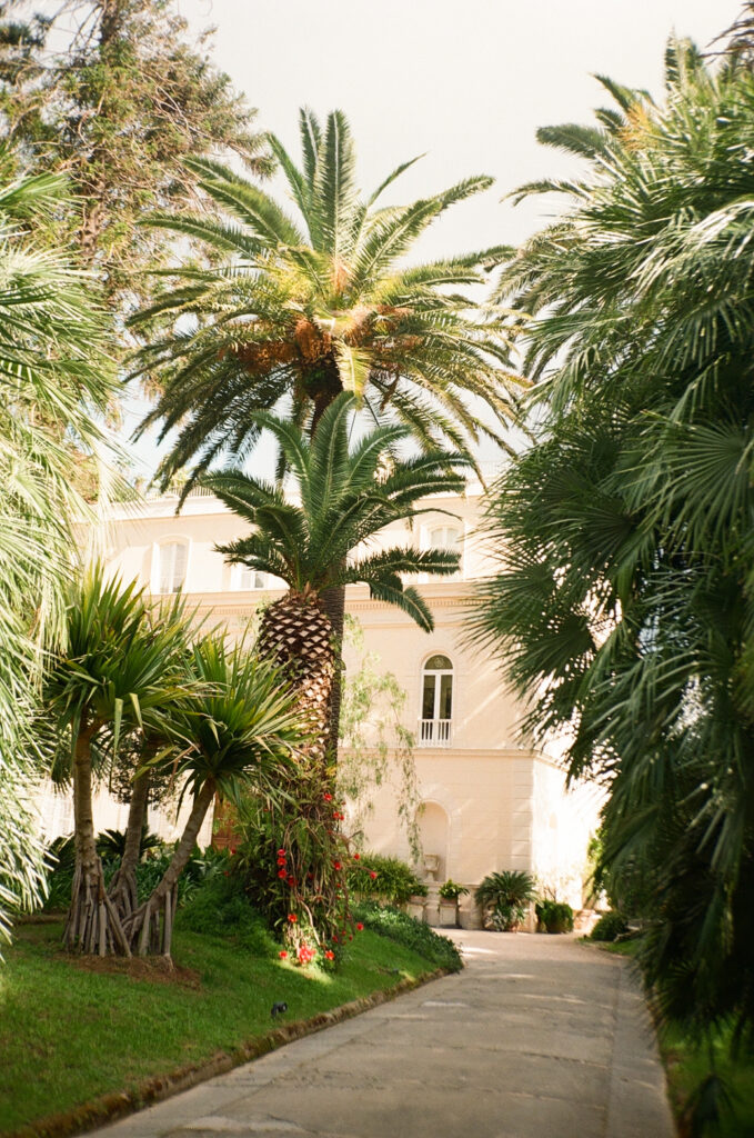 Villa Astor wedding garden pathway in Sorrento, Italy with palm trees and villa exterior